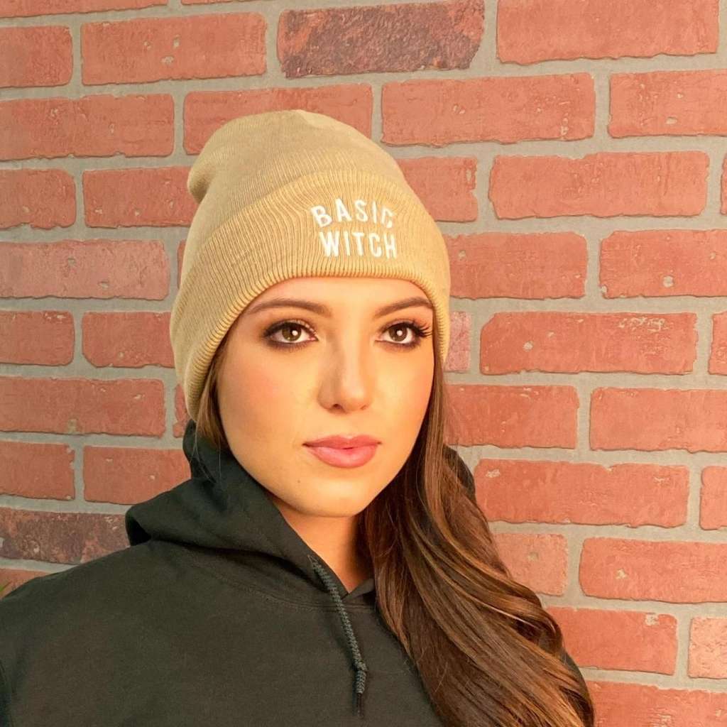 Model wearing tan cuffed beanie with BASIC WITCH embroidered in white - DSY Lifestyle