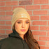Model wearing tan cuffed beanie with BASIC WITCH embroidered in white - DSY Lifestyle