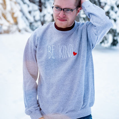 Male wearing heather gray Sweatshirt embroidered with Be Kind in the front - DSY Lifestyle