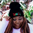 Model wearing black cuffed beanie with Believe embroidered with Christmas symbols - DSY Lifestyle