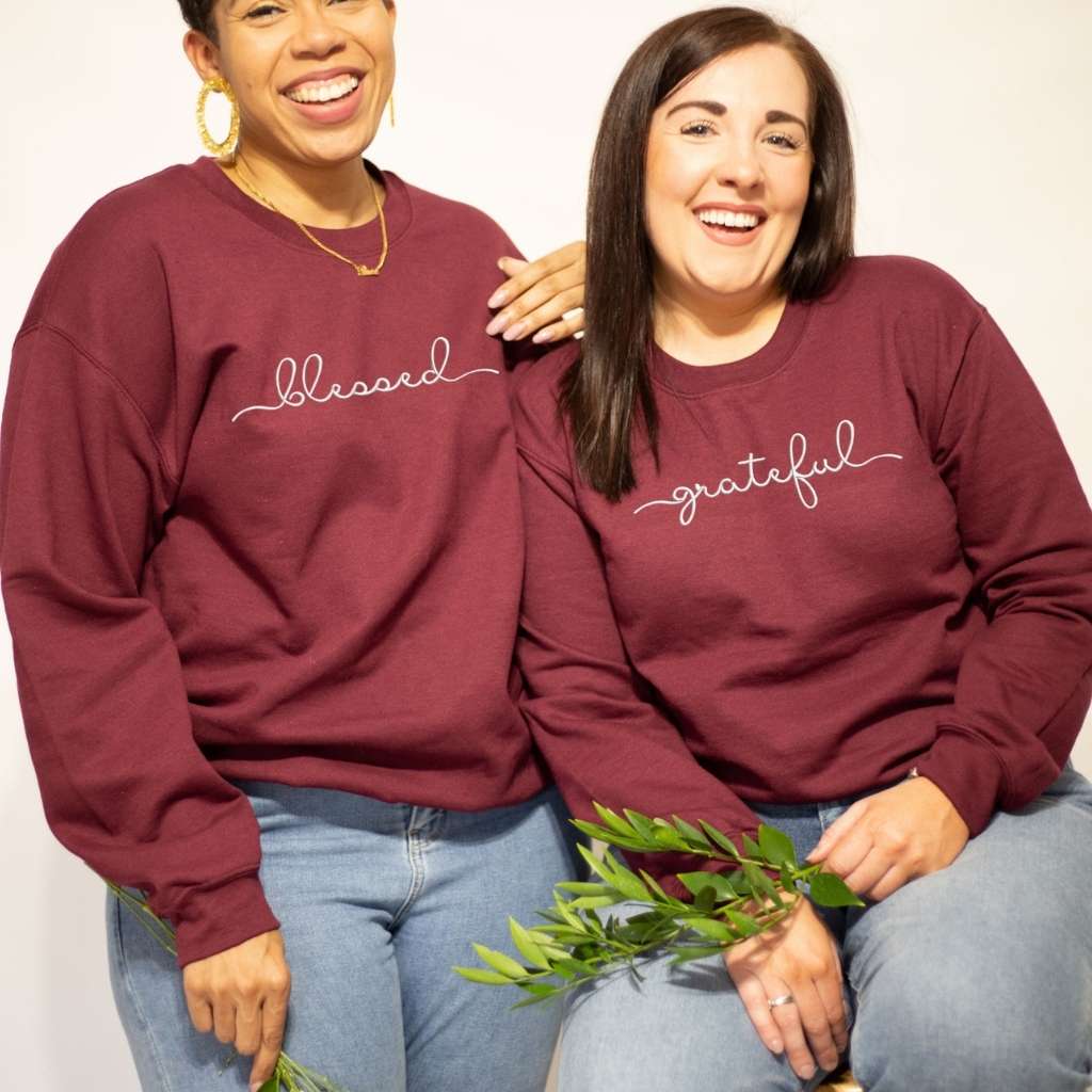 Two Female wearing maroon sweatshirts embroidered with blessed and grateful in the front - DSY Lifestyle