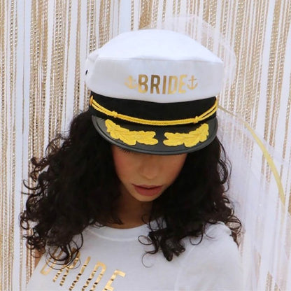 Female wearing a Captain hat with Bride printed in the front and a white veil she is also wearing a white cropped underboob with Bride printed in gold - DSY Lifestyle