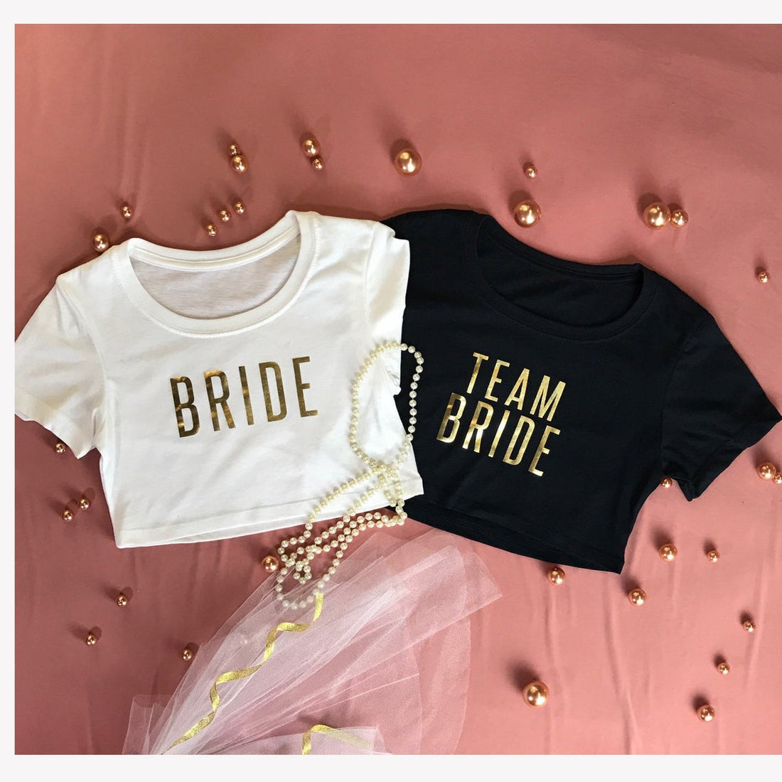 Flatlay of white bride crop top and black team bride crop top - DSY Lifestyle