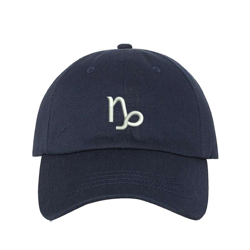 Navy blue baseball hat with Capricorn zodiac symbol embroidered in white - DSY Lifestyle 