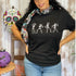 Female wearing a black unisex t-shirt with printed white dancing skeletons in the front - DSY Lifestyle