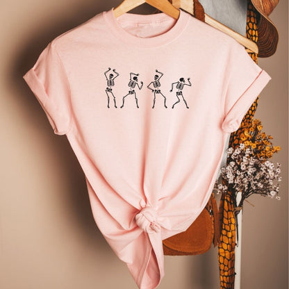 Flat lay of pink t-shirt printed with white dancing skeletons- DSY Lifestyle