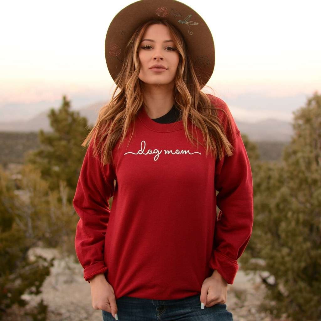 Female wearing a cardinal crewneck sweatshirt embroidered with dog mom - DSY Lifestyle