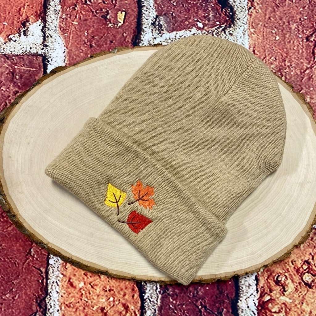 Tan cuffed beanie with orange, yellow, and red fall leaves embroidered on the front - DSY Lifestyle