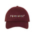 Burgundy baseball hat with FEMINIST embroidered in white with multicolored dots in between letters - DSY Lifestyle