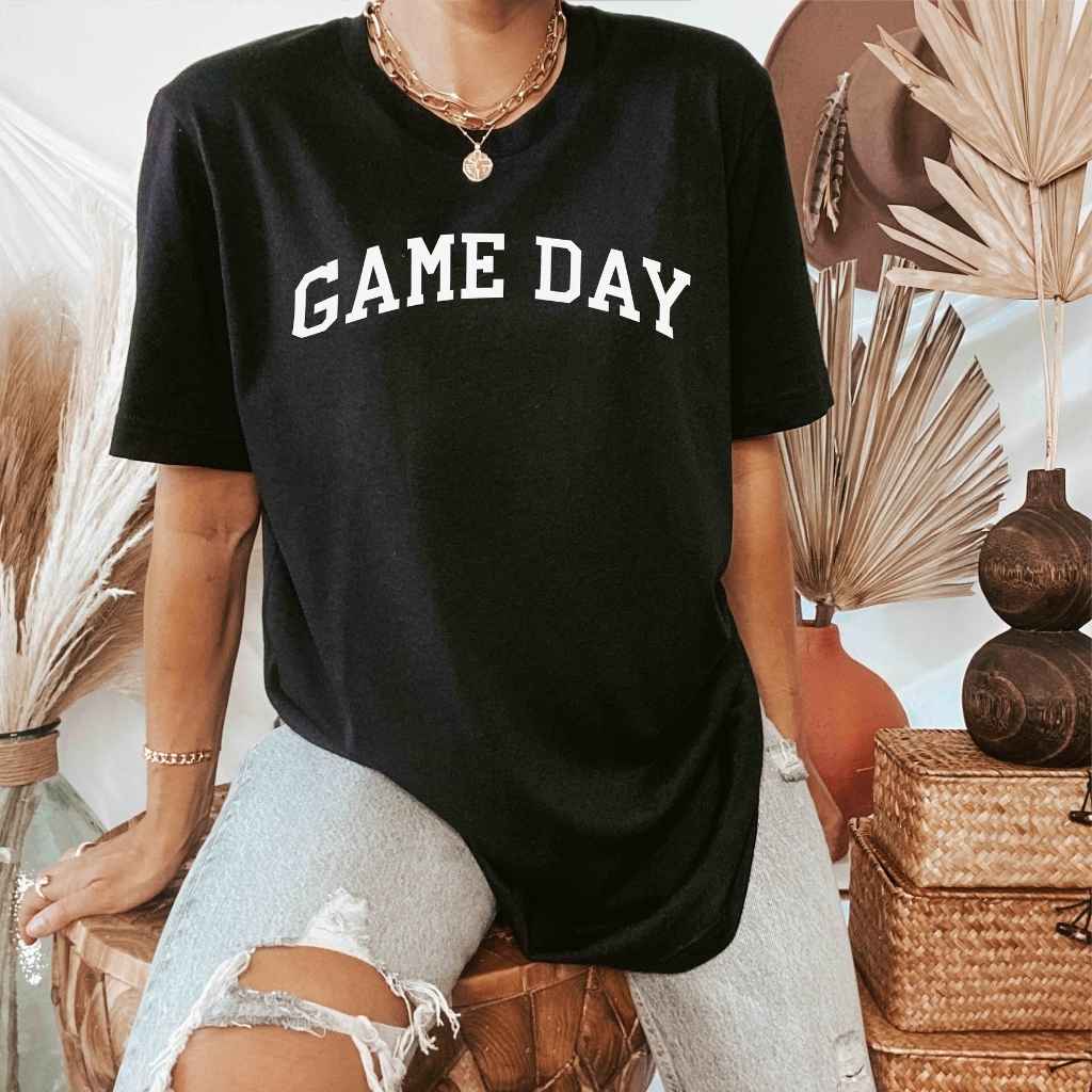 Female wearing a black t-shirt printed with Game Day in white - DSY Lifestyle