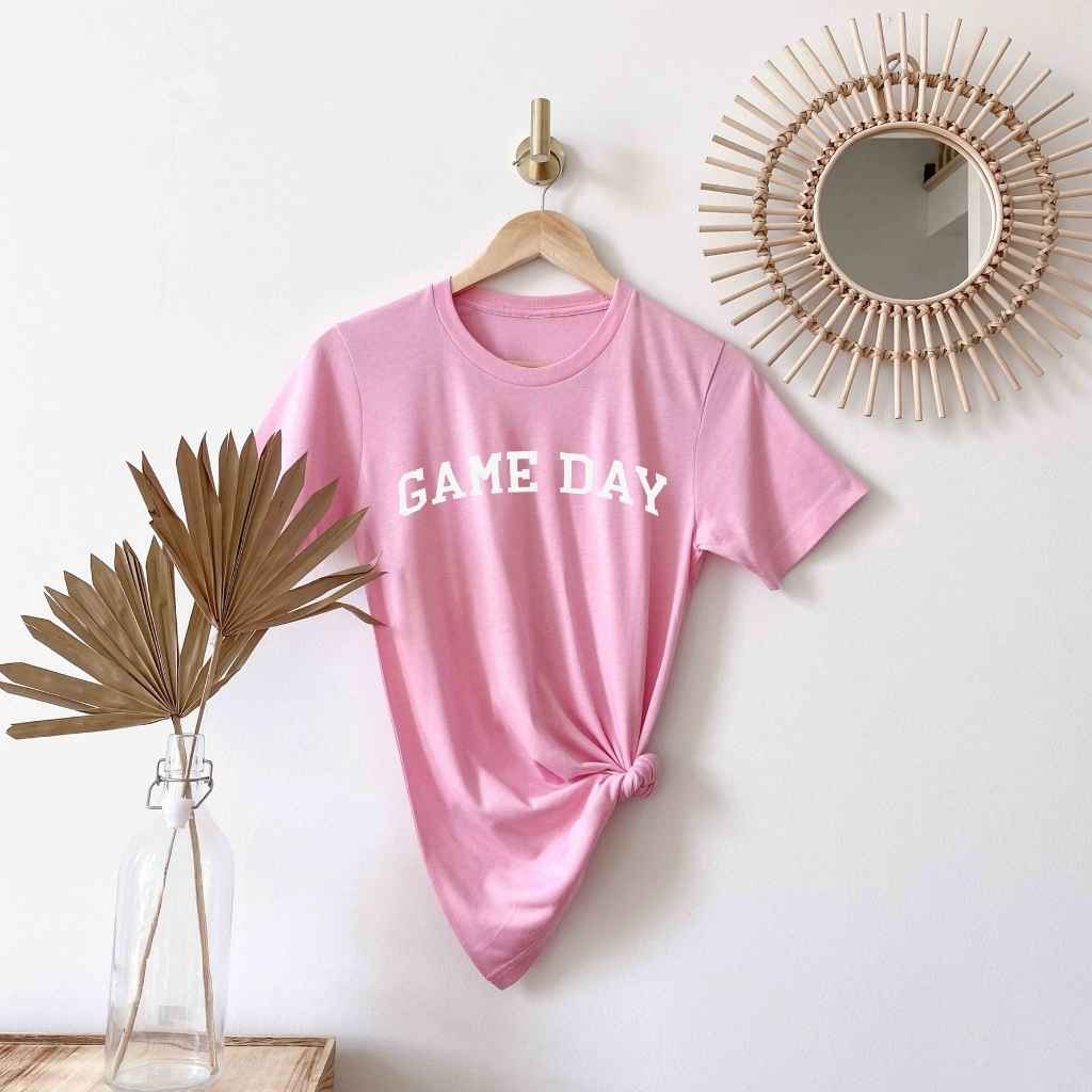 Flat Lay of Pink t-shirt printed with Game Day in white - DSY Lifestyle