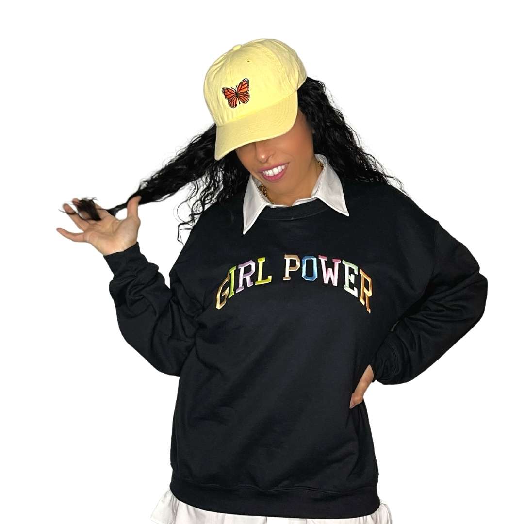 Female wearing a black sweatshirt embroidered with girl power in pastel colors - DSY Lifestyle