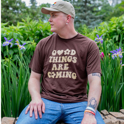 Male wearing a brown tshirt printed with Good Things are coming - DSY Lifestyle