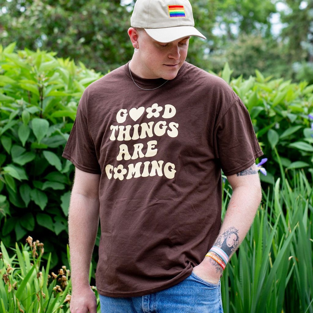 Male wearing a brown tshirt printed with Good Things are coming - DSY Lifestyle