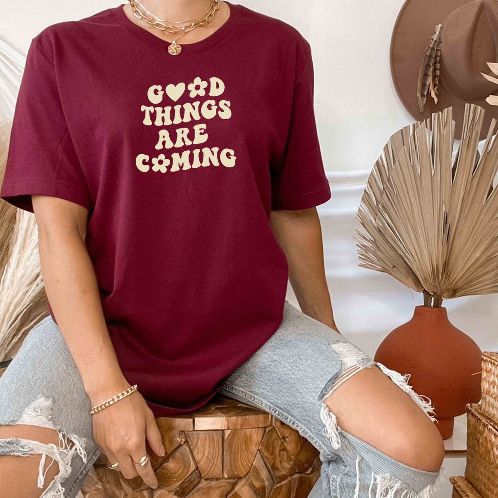 Male wearing a burgundy tshirt printed with Good Things are coming - DSY Lifestyle