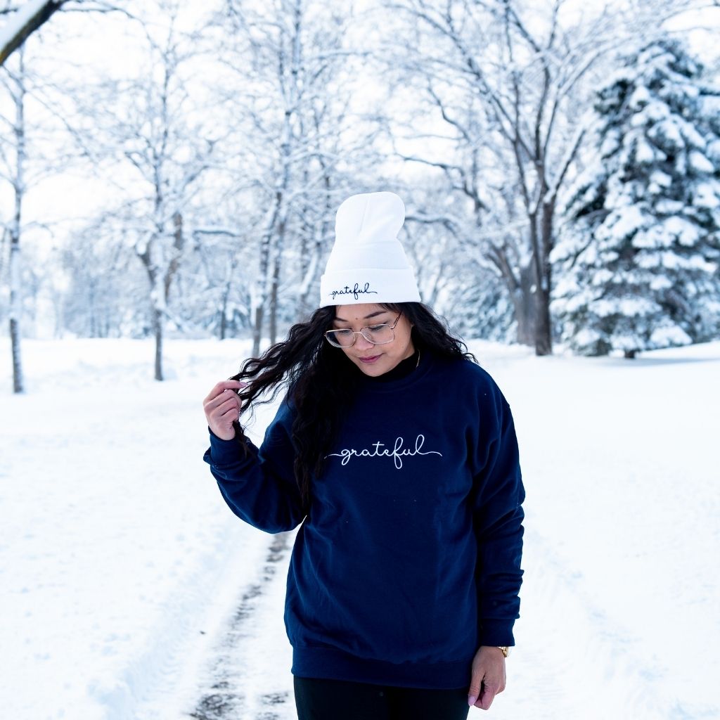 Female wearing a navy blue sweatshirt embroidered with grateful - DSY Lifestyle