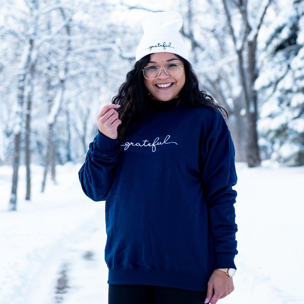 Female wearing a navy blue sweatshirt embroidered with grateful - DSY Lifestyle