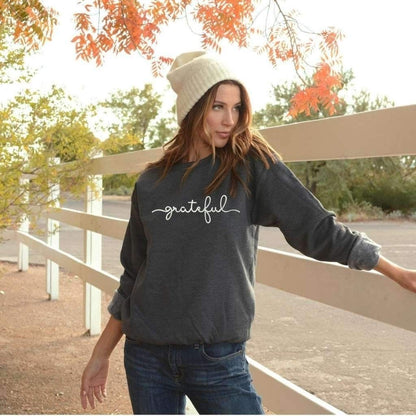 Female wearing a dark heather gray sweatshirt embroidered with grateful - DSY Lifestyle
