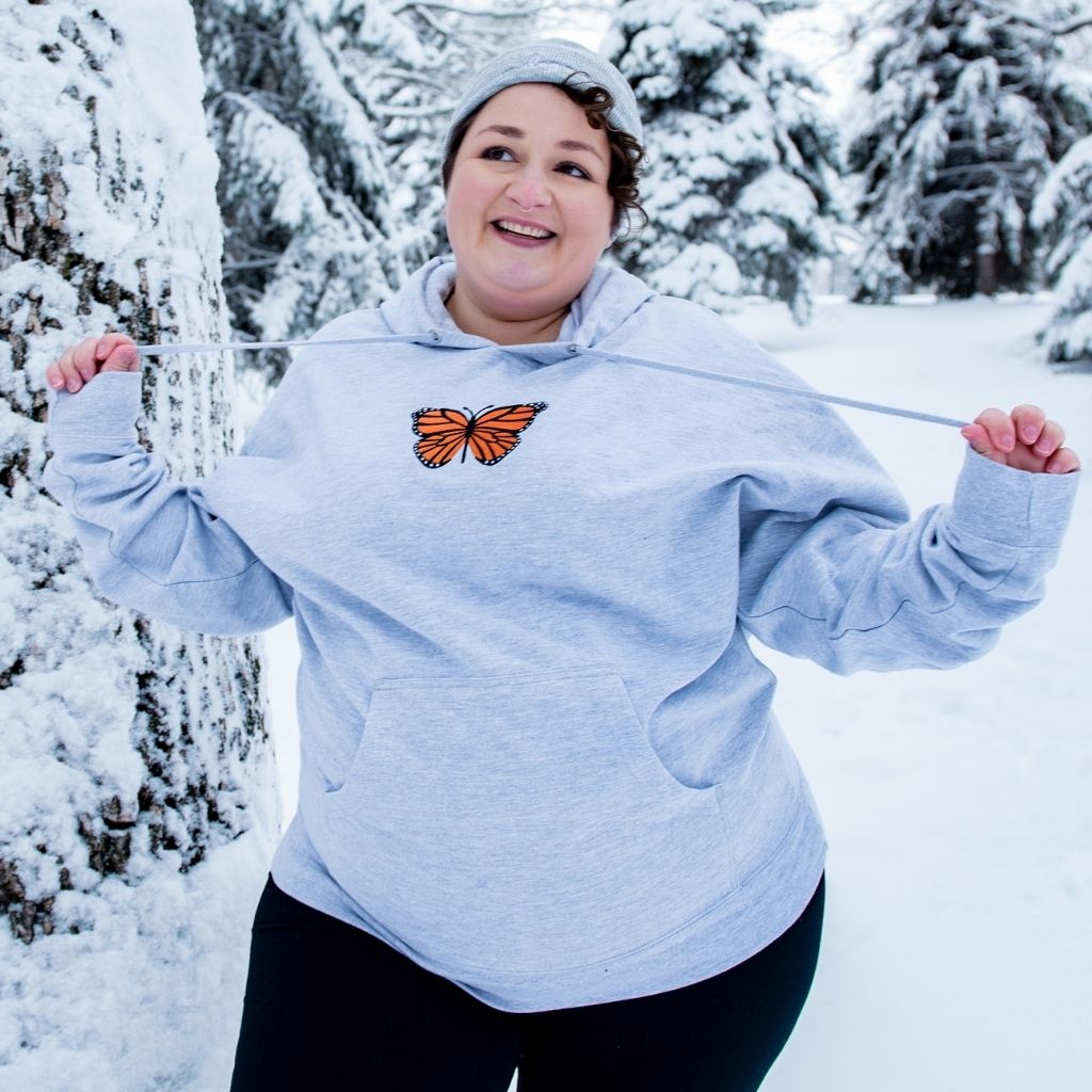 Female wearing a gray hoodie with a monarch butterfly embroidered in the front-DSY Lifestyle
