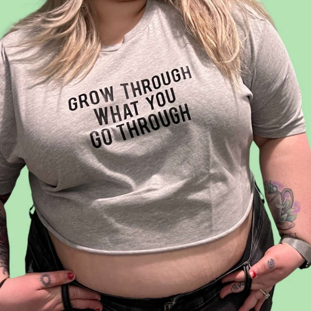 Woman wearing a gray cropped tee with Grow through what you go through printed in black - DSY Lifestyle