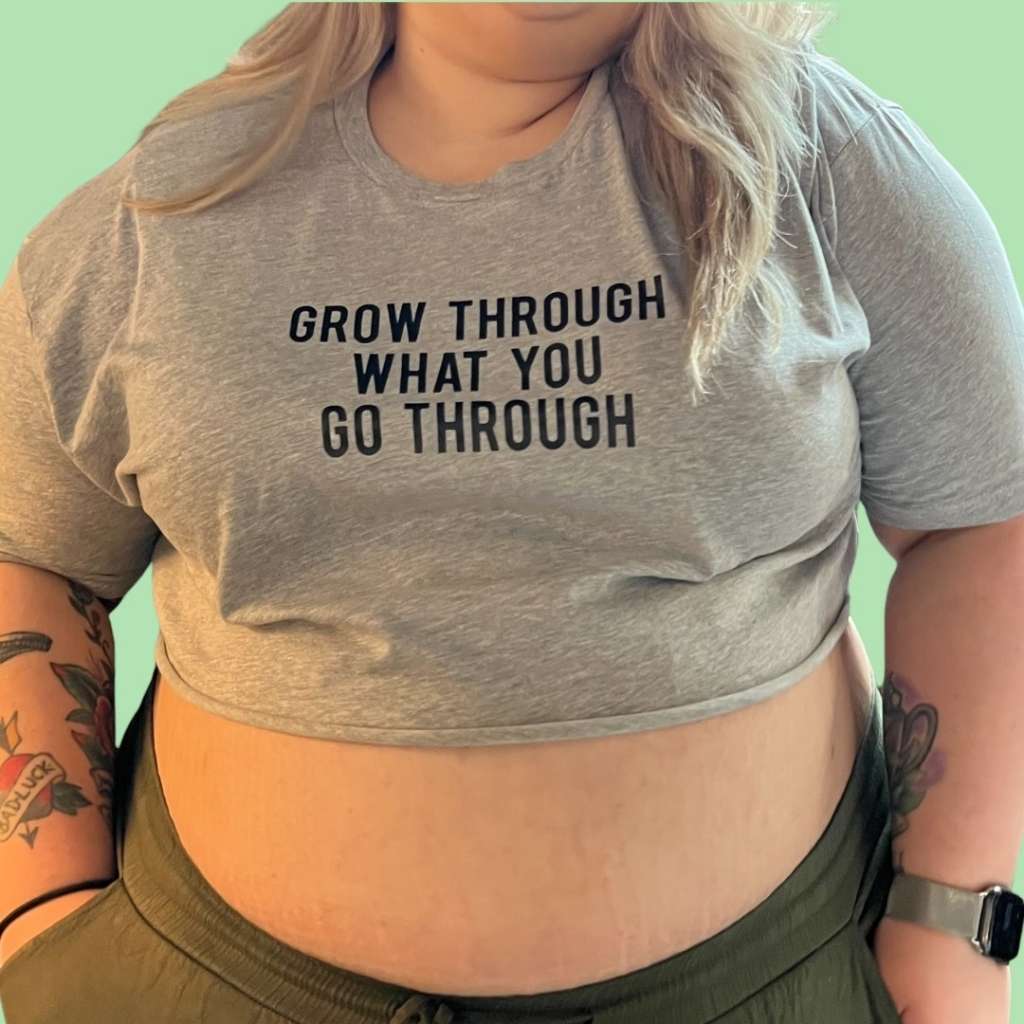 Woman wearing a gray cropped tee with Grow through what you go through printed in black - DSY Lifestyle