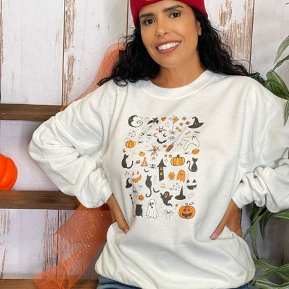 Woman wearing a over sized white sweatshirt with halloween doodles printed on the front- DSY Lifestyle