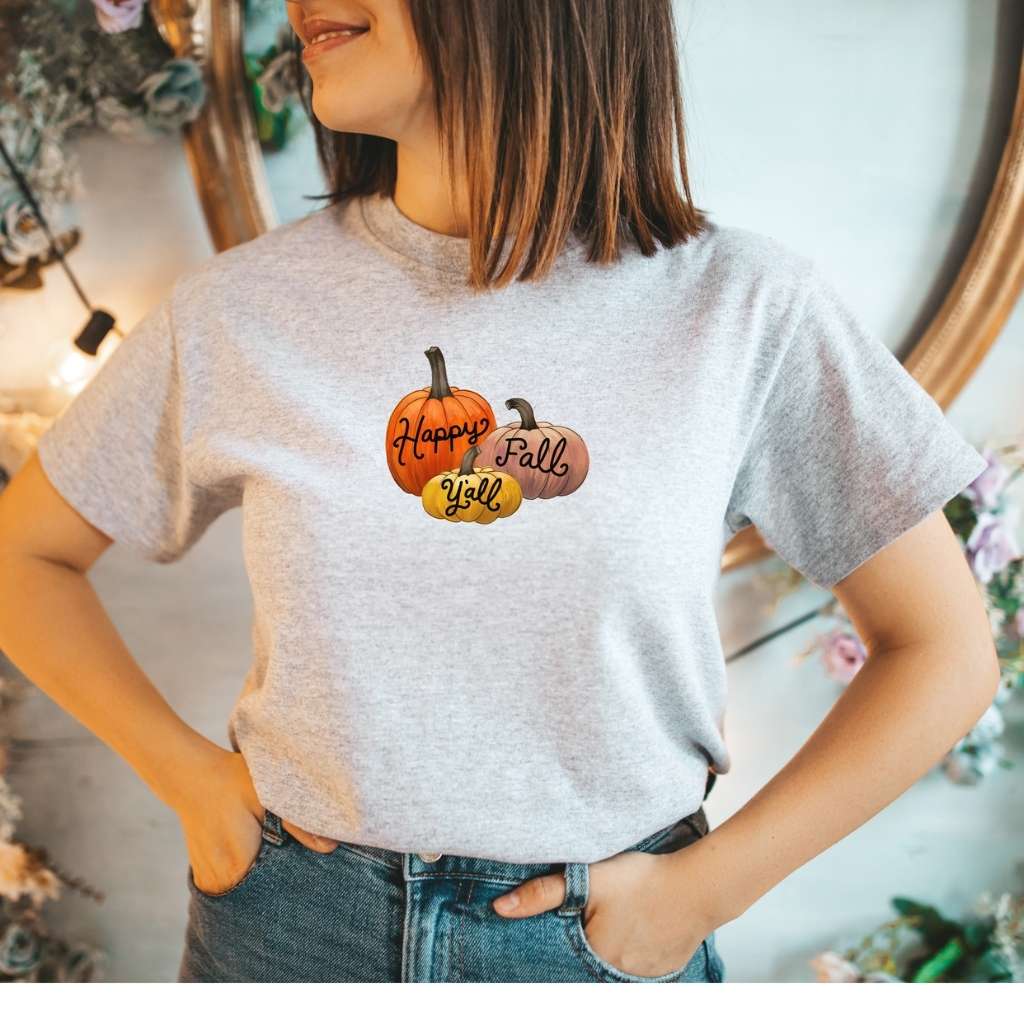 Female wearing a heather gray unisex t-shirt with Happy Fall Ya&