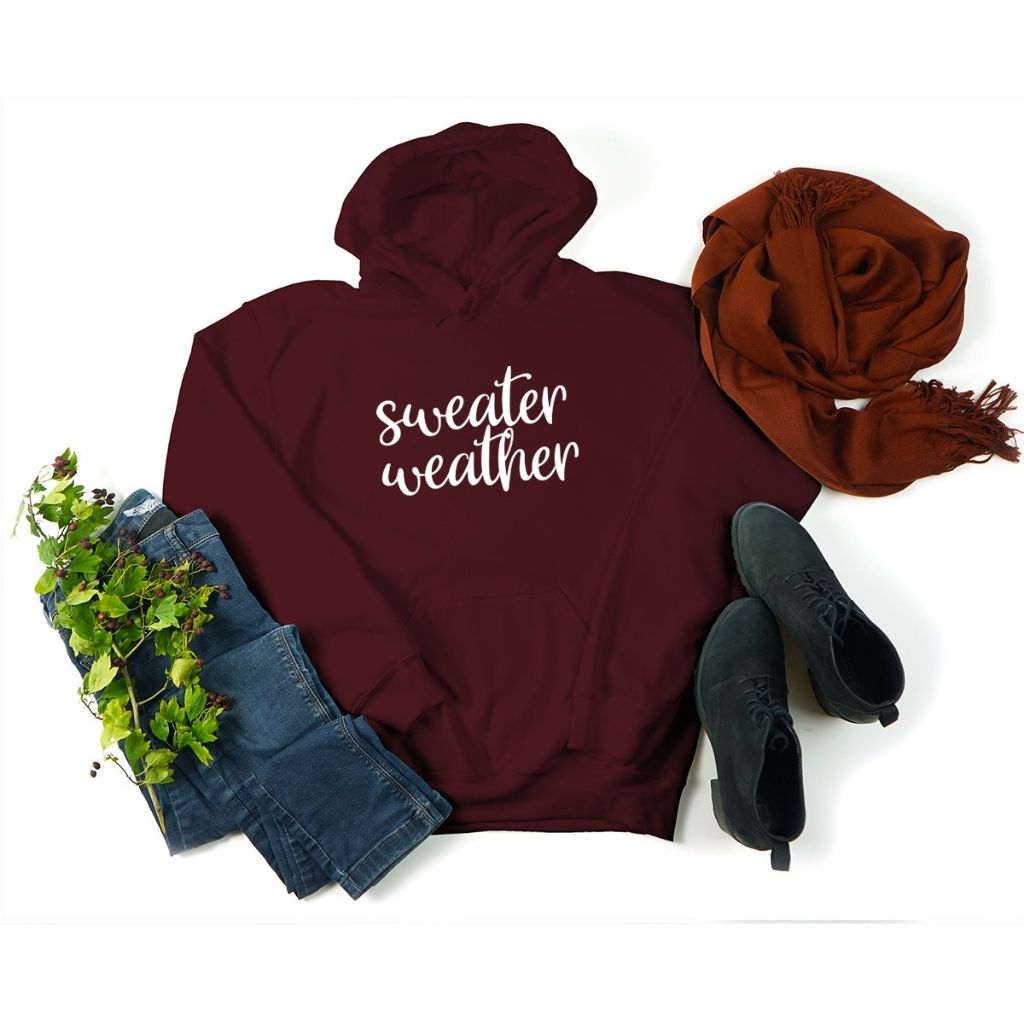 Female wearing a Maroon Hoodie Sweatshirt with sweater weather embroidered in the front - DSY Lifestyle