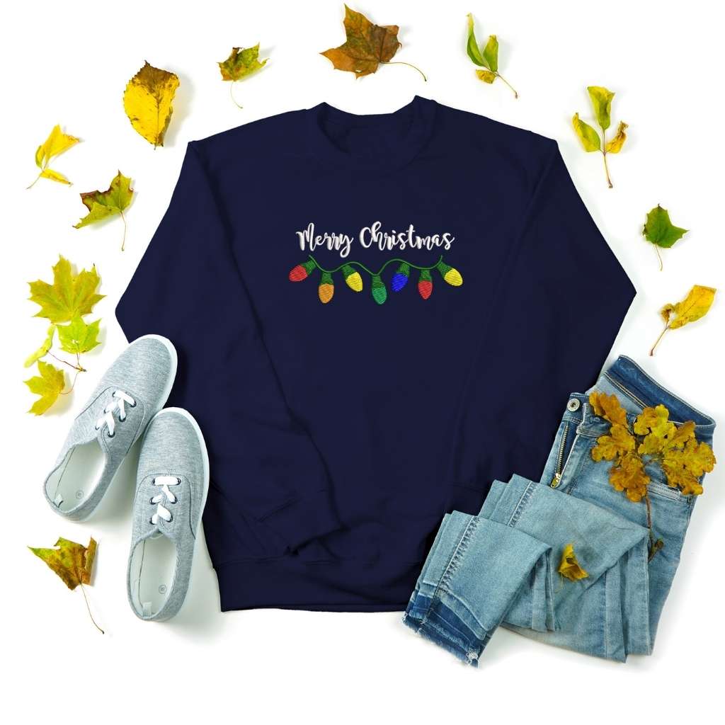 Flat lay of a navy sweatshirt with Merry Christmas embroidered in the front - DSY Lifestyle