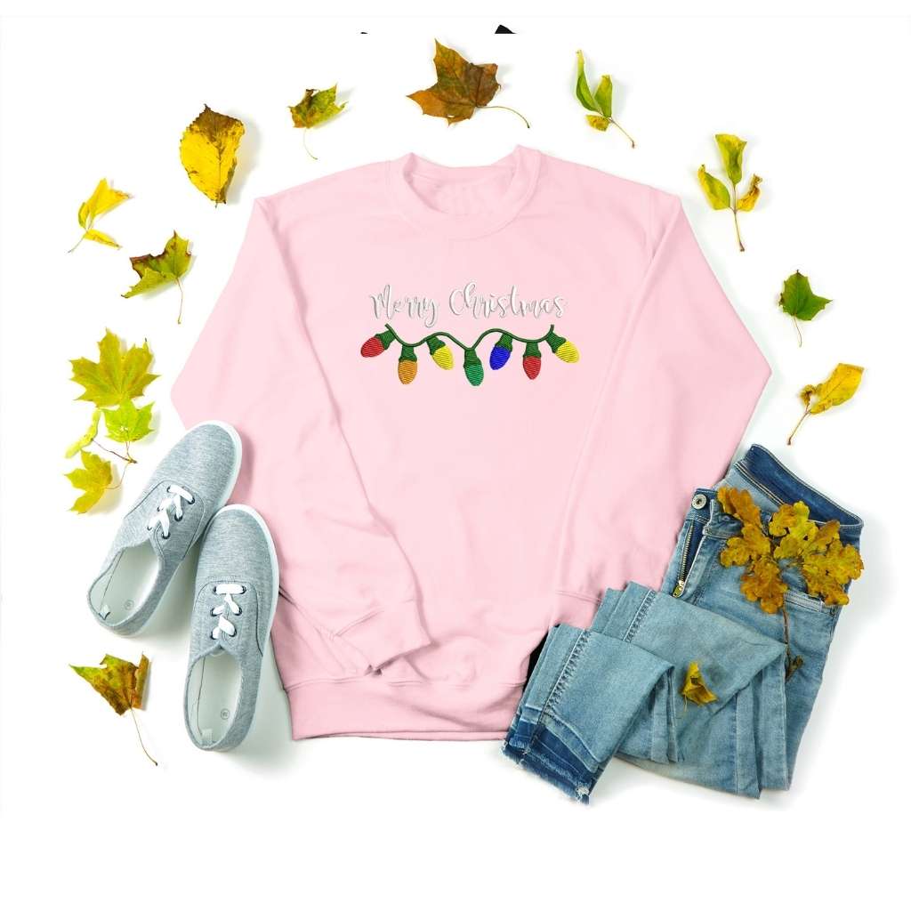 Flat lay of a pink sweatshirt with Merry Christmas embroidered in the front - DSY Lifestyle