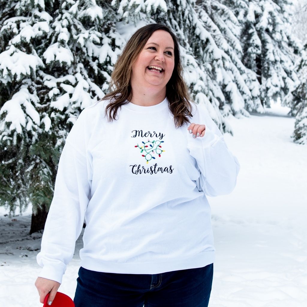 Female wearing a white sweatshirt embroidered with Merry Christmas in the front - DSY Lifestyle