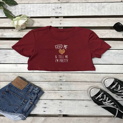 Flat lay of cardinal underboob top with feed me pizza and call me pretty printed on the front in white - DSY Lifestyle