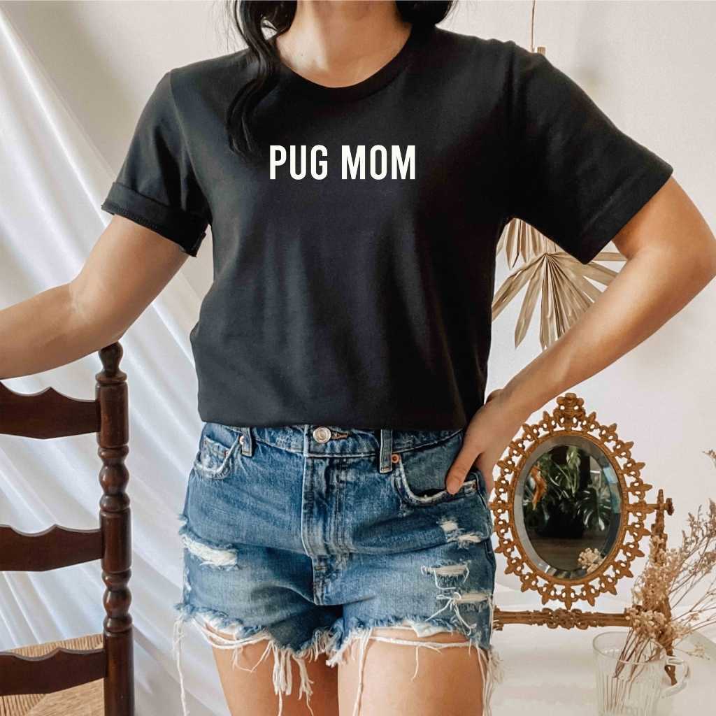 Female wearing a black shirt with Pug Mom printed in the front - DSY Lifestyle