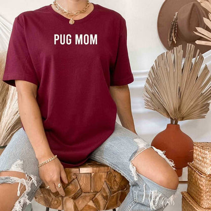 Female wearing a burgundy shirt with Pug Mom printed in the front - DSY Lifestyle