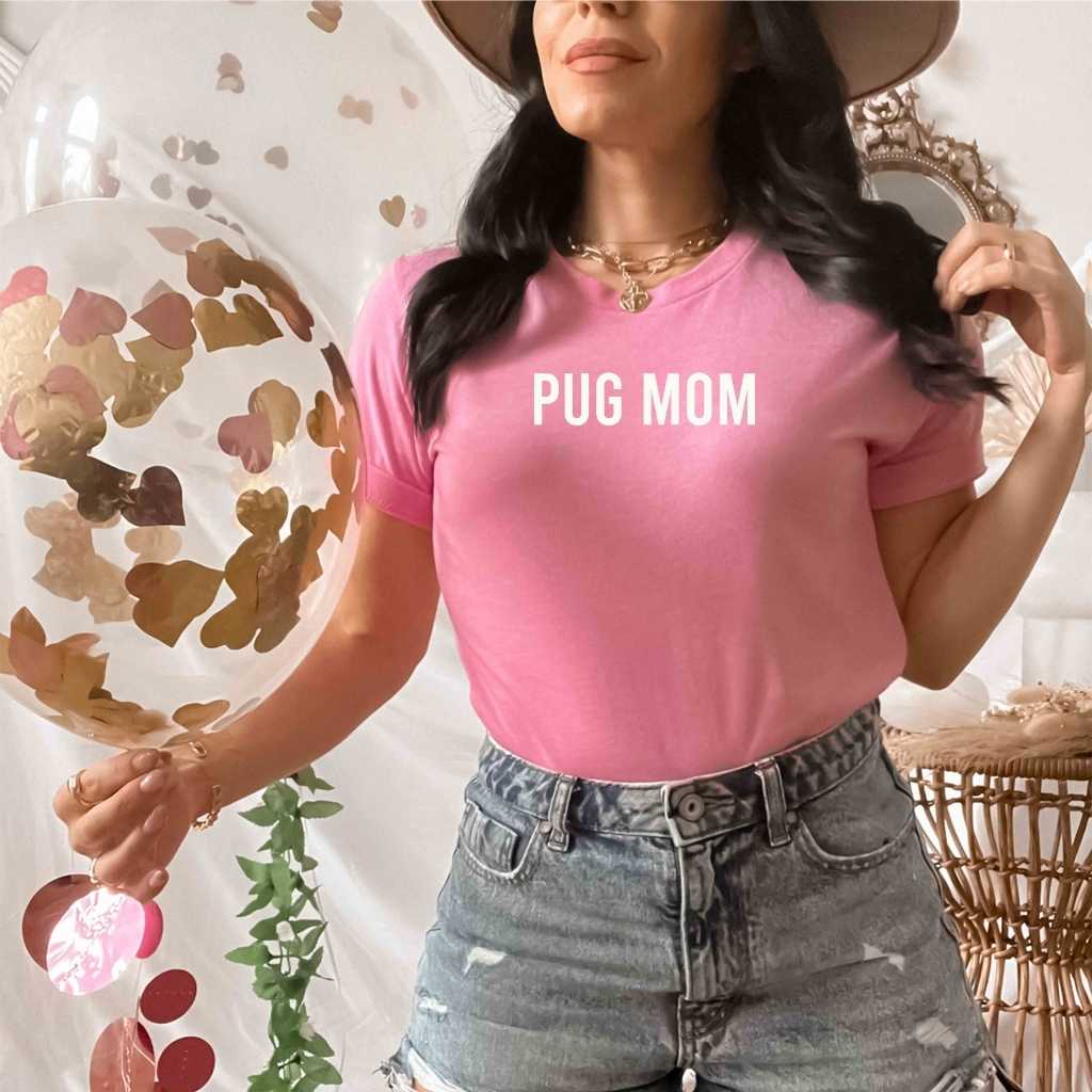 Female wearing a pink shirt with Pug Mom printed in the front - DSY Lifestyle