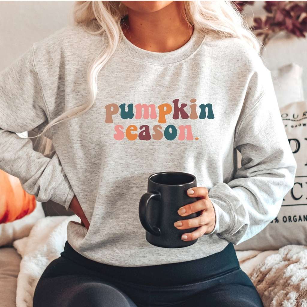 Female wearing a heather gray crewneck sweatshirt printed with pumpkin season in the front - DSY Lifestyle