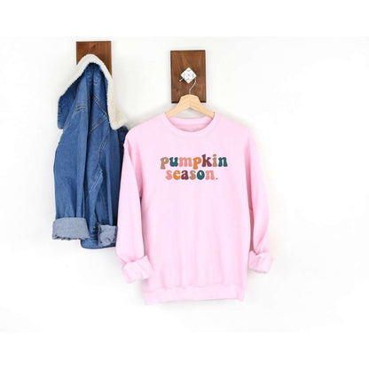Female wearing a light pink crewneck sweatshirt printed with pumpkin season in the front - DSY Lifestyle