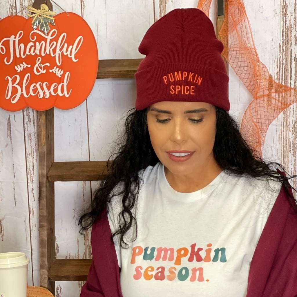 Model wearing burgundy cuffed beanie with PUMPKIN SPICE embroidered in orange - DSY Lifestyle