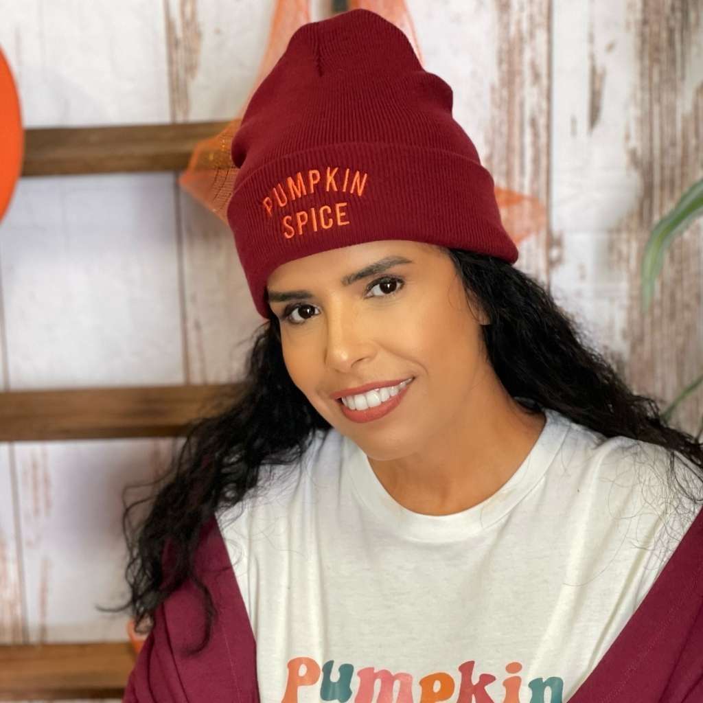 Model wearing burgundy cuffed beanie with PUMPKIN SPICE embroidered in orange - DSY Lifestyle