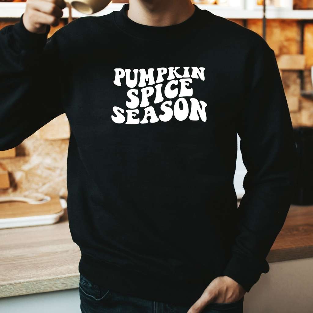 male wearing a black sweatshirt with pumpkin spice season printed in white - DSY Lifestyle