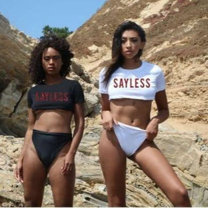 Two Females wearing a black and white underboob top with sayless on the front in red glitter vinyl - DSY Lifestyle