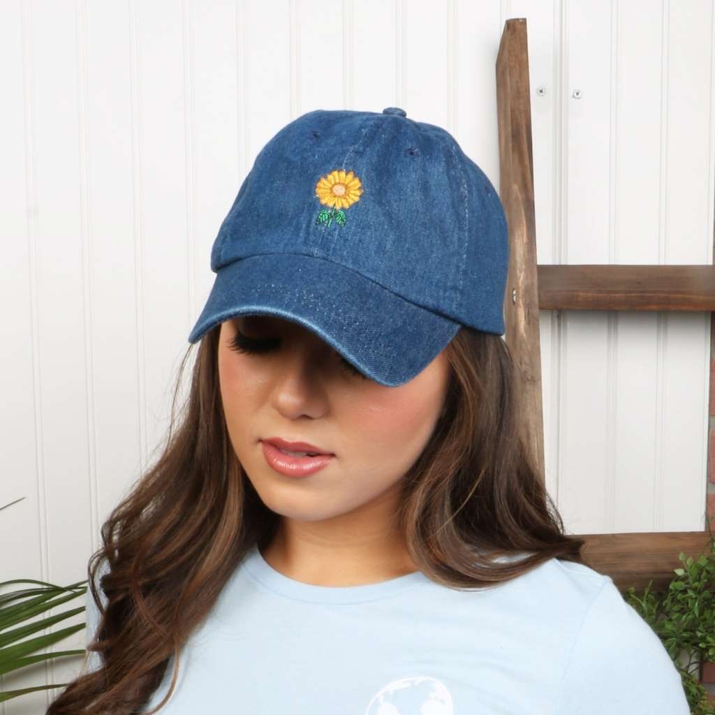 Female wearing a dark denim baseball hat embroidered with a sunflower - DSY Lifestyle