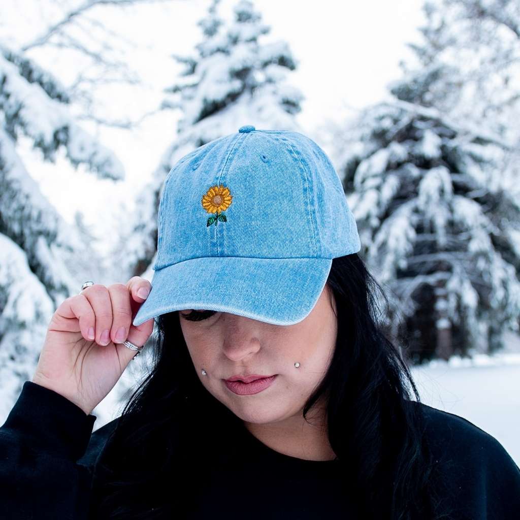 Female wearing a denim baseball hat embroidered with a sunflower - DSY Lifestyle