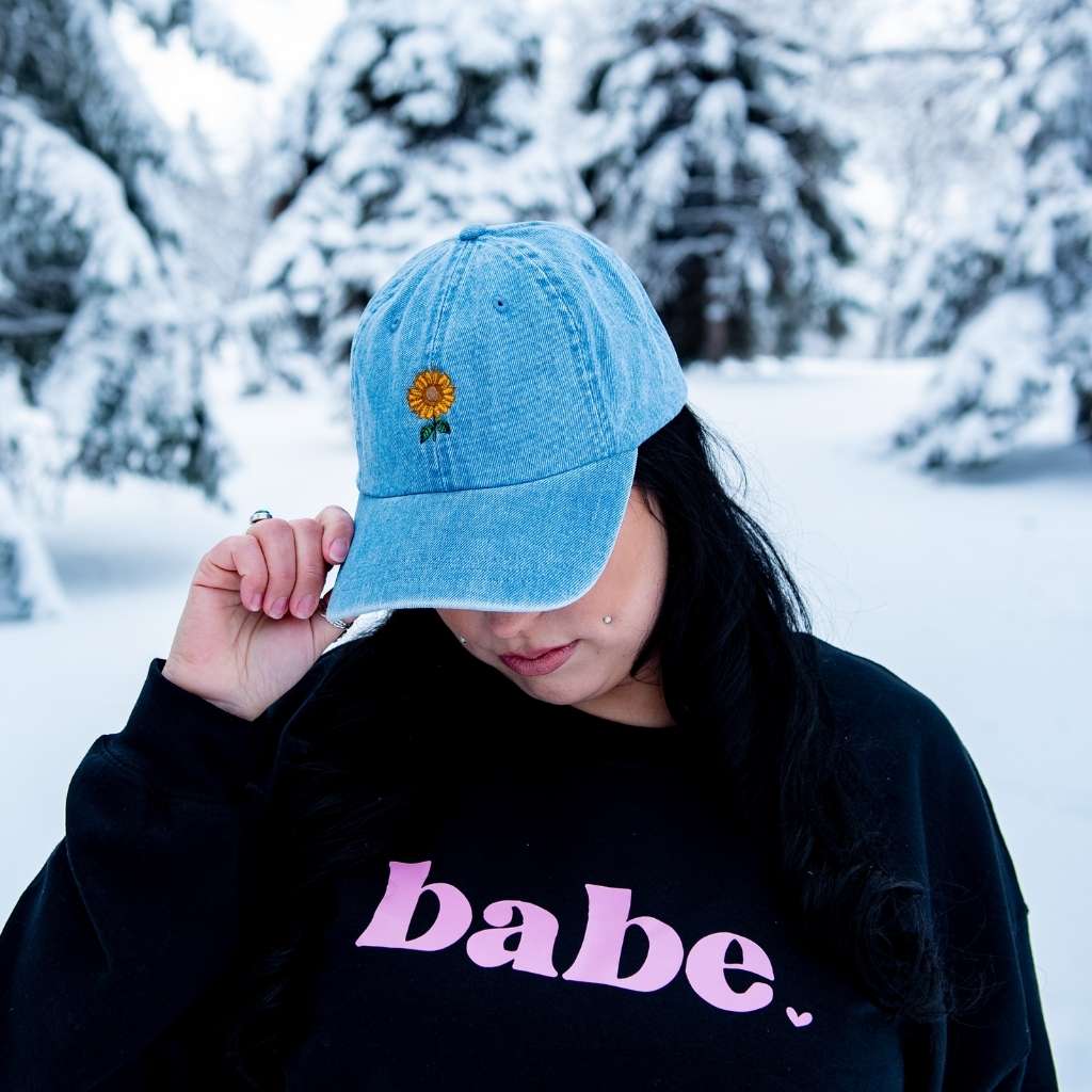 Female wearing a denim baseball hat embroidered with a sunflower - DSY Lifestyle