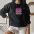 Female wearing a black sweatshirt embroidered with XOXO in shades of Pink - DSY Lifestyle