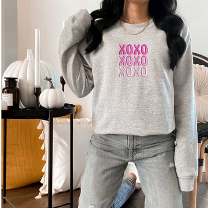 Female wearing a Heather Gray sweatshirt embroidered with XOXO in shades of Pink - DSY Lifestyle