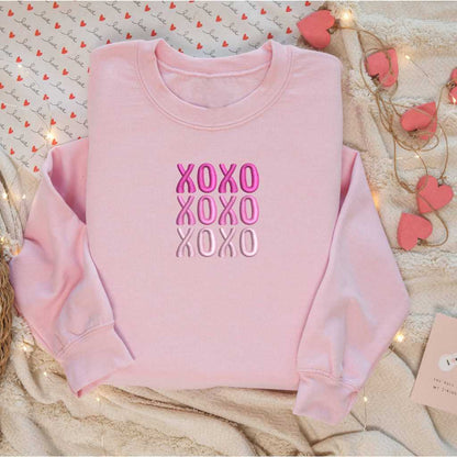 Flatlay of a Pink sweatshirt embroidered with XOXO in shades of Pink - DSY Lifestyle