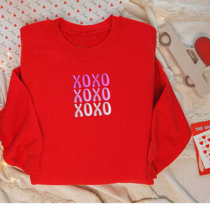 Flatlay of Red sweatshirt embroidered with XOXO in shades of Pink - DSY Lifestyle
