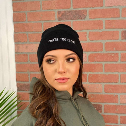 Female modeling black cuffed beanie with You&