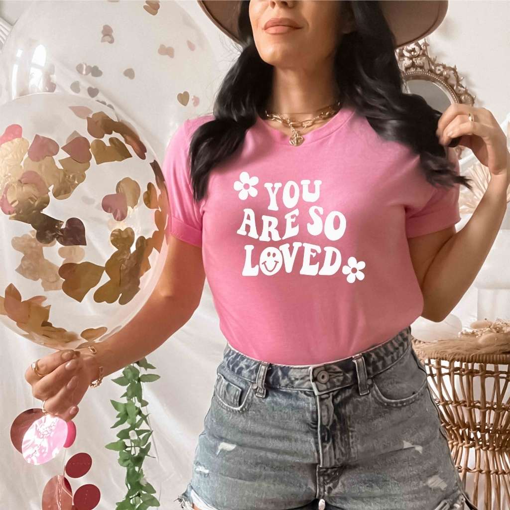Female wearing a pink tshirt with You are so loved - DSY Lifestyle